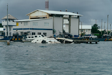 Capsized boats in harbour after a storm on San Andres, Colombia