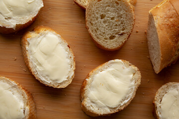 Homemade Bread and Butter on a bamboo board, top view. Flat lay, overhead, from above.