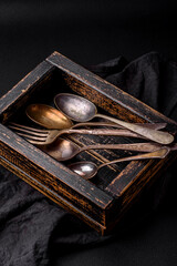 Vintage rectangular shabby wooden box with spoons and forks