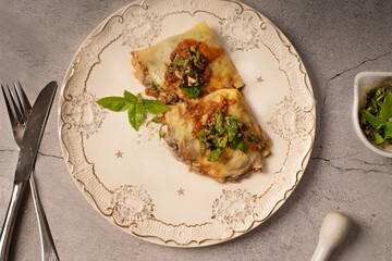Crepes filled with steak, mushrooms, and vegetables