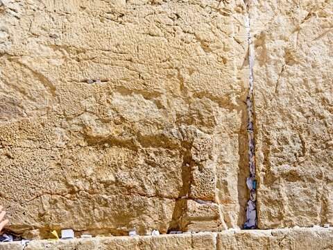 Texture of the stones with notes inserted in crevices of the  Western Wall (Wailing Wall), Jerusalem, Israel