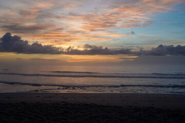Obraz premium Sunset on the beach with calm waves