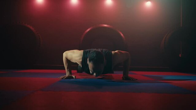 Man making the push up with claps hand in the gym training sport