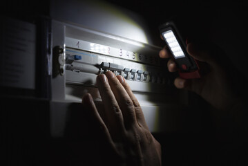 Investigate a home fuse box during a power outage