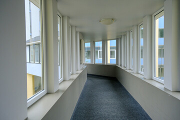 A walkway or corridor or hallway between buildings. A corridor with a slight twist