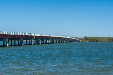 Fototapeta na wymiar Bribie Island bridge crossing Sandstone Passage, viewed from Sylvan Beach on Bribie Island, Queensland, Australia