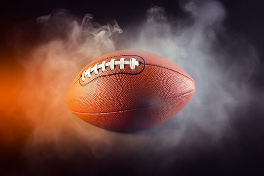 Bola de futebol americano no fundo de fumaça de cor