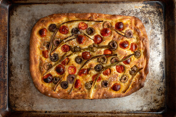 Focaccia with roasted tomatoes, olives, and scallions