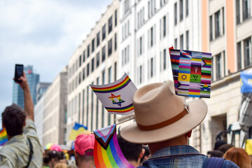 Christopher Street Day Berlin.Pride, 23 July 2022. LGBT flags hang colourful on a hat. Men...