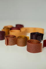 Fruit marshmallows rolled up lies on the table