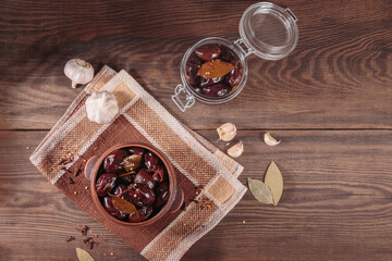 Obraz na płótnie Canvas Bowl of pickled plums with spices