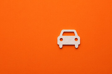 White car on orange colored background - car symbol for web site design or logo