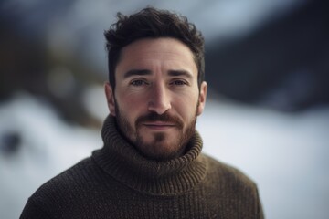 Portrait of a handsome man with a beard in a winter landscape
