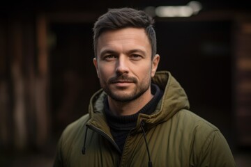 Obraz premium Headshot portrait photography of a satisfied man in his 30s wearing a comfortable tracksuit against a rustic barn or farm background. Generative AI