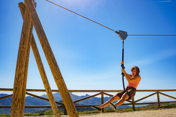 Adult woman having fun on zipline