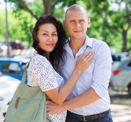 Fototapeta premium Woman and man hugging each other in parking lot