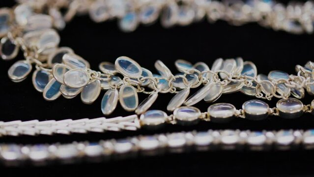 Moonstone jewelry on display stand. Short necklace of Moonstone. Handmade jewelry made from natural stones. Modern Author's jewelry. ProRes 422, 10 bit video