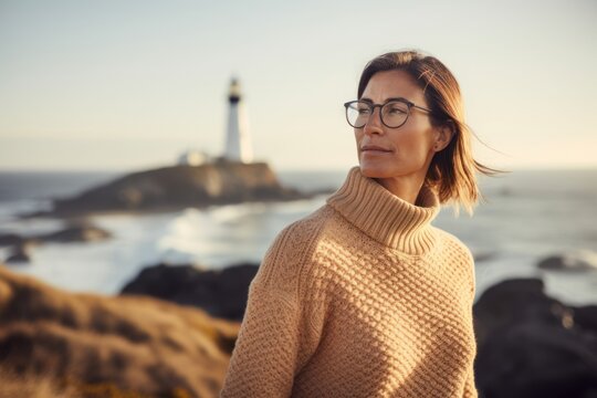 Group portrait photography of a pleased woman in her 30s wearing a cozy sweater against a lighthouse or coastal background. Generative AI