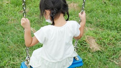公園のブランコで遊ぶ子供