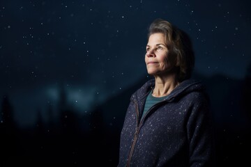 Portrait of a beautiful senior woman on a background of the night sky