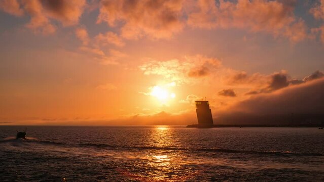 Time lapse of Torre VTS de Lisboa - VTS Vessel Traffic System tower - Centre for Coordination and Control of Maritime Traffic and Safety of Lisbon on bank of Tagus river, Portugal on sunset