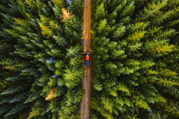 Aerial shot of shot of a pickup truck driving through the forest of Washington state