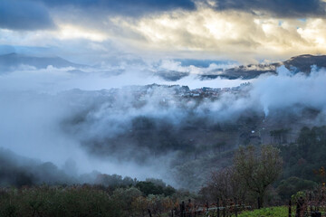 Landscape of the village of Sabroso on the outskirts of Vila Real in Portugal, shrouded in clouds and mist after heavy rain, on a stormy day.