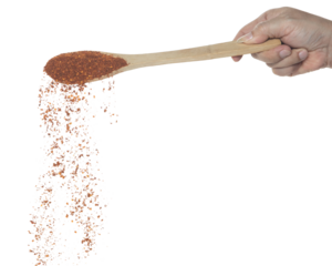 Red Hot Chilli fall, red grain chilli explode abstract cloud fly from wooden spoon. Beautiful complete seed chilly, food object design. Selective focus freeze shot white background isolated