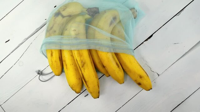 Bunch of ripe bananas in eco-friendly grid rotate.