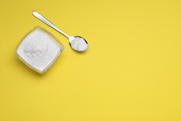 Sweet powdered fructose on yellow background, flat lay. Space for text