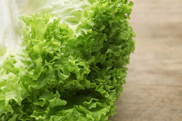 Fresh lettuce on wooden table, closeup. Salad greens