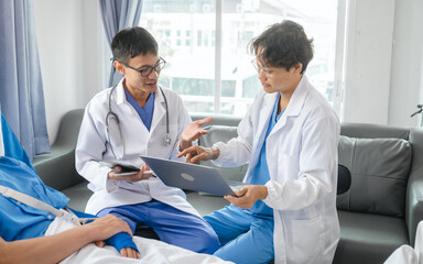 Obraz premium The medical team visits the car accident patients who are lying on the nursing bed and arm cast with wrapping nurse bandages splint to the arm.