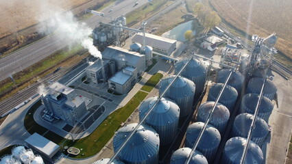 Grain elevator. Granary. Large metal structure grain elevator. Storage facility for grain. Top view. Grain storage. Silos. Metal hangar for cereal. Modern new elevator plant. agricultural agribusiness