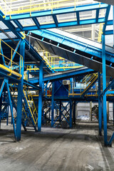 System of conveyors carrying trash at waste processing plant