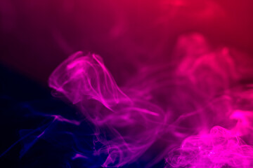 Colorful smoke on a black background. Rainbow abstract light texture smoke background.