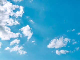 Obraz premium Blue sky with white fluffy clouds. Pastel sky with clouds background. Photo can be used for the concept of freedom of life, new life beginning and the power of positive thought. 