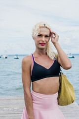 portrait of young transgender woman wearing woman makeup at the beach in Mexico Latin America, hispanic lgbt community