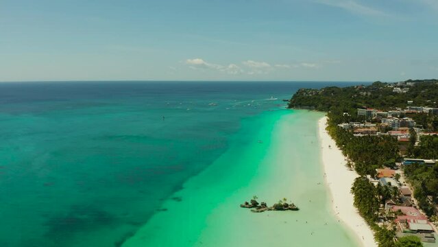 Tropical white sand beach, hotels near the blue lagoon and corall reef. aerial view, Boracay, Philippines. Seascape with beach on tropical island. Summer and travel vacation concept.