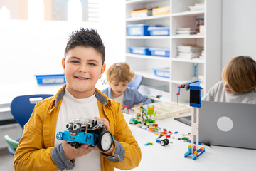 Robotics programming class. Children construct and code Robot. STEM education using constructor...