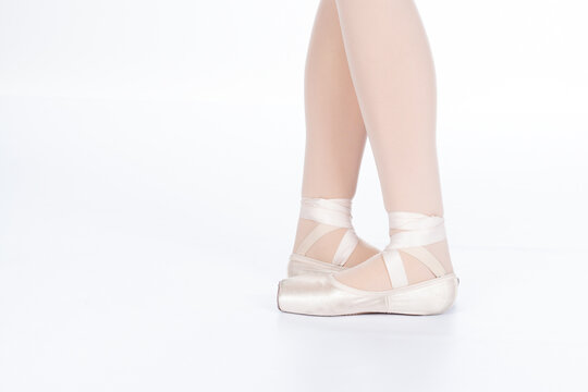 En Pointe CORRECT Fifth position closed with calves front on teachers perspective Close up of young female ballet dancer showing various classic ballet feet positions pointe shoes