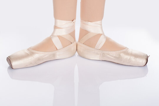 En Pointe CORRECT First position open front on teachers perspective Close up of young female ballet dancer showing various classic ballet feet positions pointe shoes