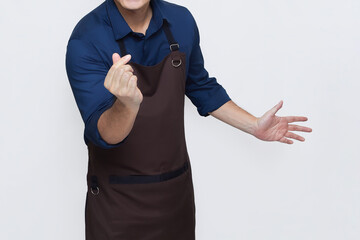 Asian Man wearing Apron in casual stylish clothing, standing upright pose with fingers making the saranghaeyo or 'I love you' gesture in Korean, no face isolated white background