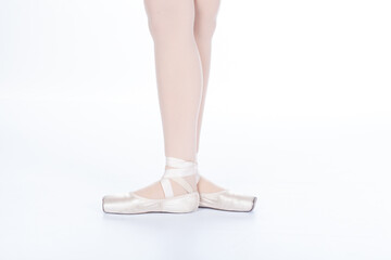 En Pointe CORRECT Third position showing calves front on teachers perspective Close up of young female ballet dancer showing various classic ballet feet positions © EdwardsMediaOnline
