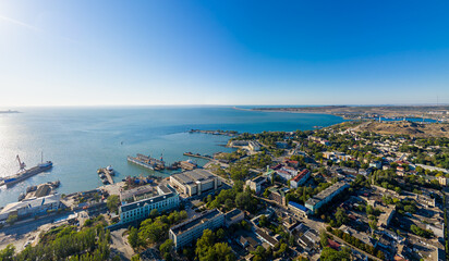 Kerch, Crimea - August 31, 2020: Panorama of the city, port and Crimean bridge from the air