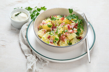Kartoffelsalat - traditional German potato salad. Potato salad with bacon.