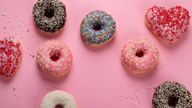 Tasty donuts on pink background. National donuts day.