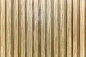 The surface of a yellow-brown wooden slatted panel. Decor and interior design, construction and renovation. Space for text.