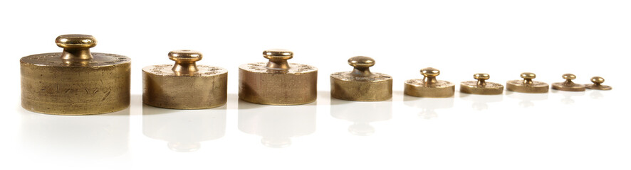 Old brass weights isolated on white background - Panorama