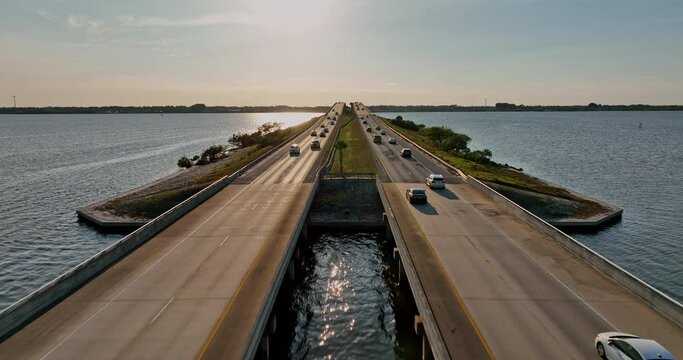 Merritt Island Florida Aerial v9 cinematic sunset view capturing traffics driving on Pineda Causeway bridge, interstate highway 404 running across Indian river - Shot with Mavic 3 Cine - March 2022