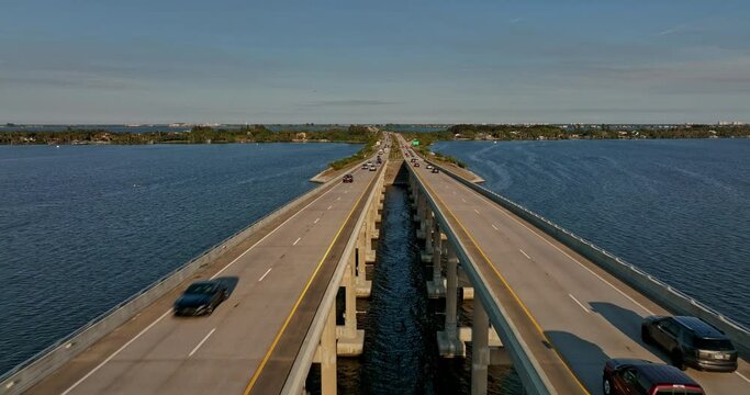 Merritt Island Florida Aerial v8 cinematic drone flyover Indian river, flying straight above Pineda Causeway capturing commuters traffics on the road bridge - Shot with Mavic 3 Cine - March 2022